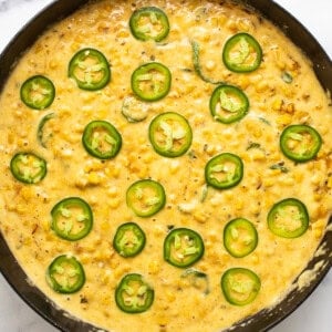 A skillet filled with corn and jalapenos.