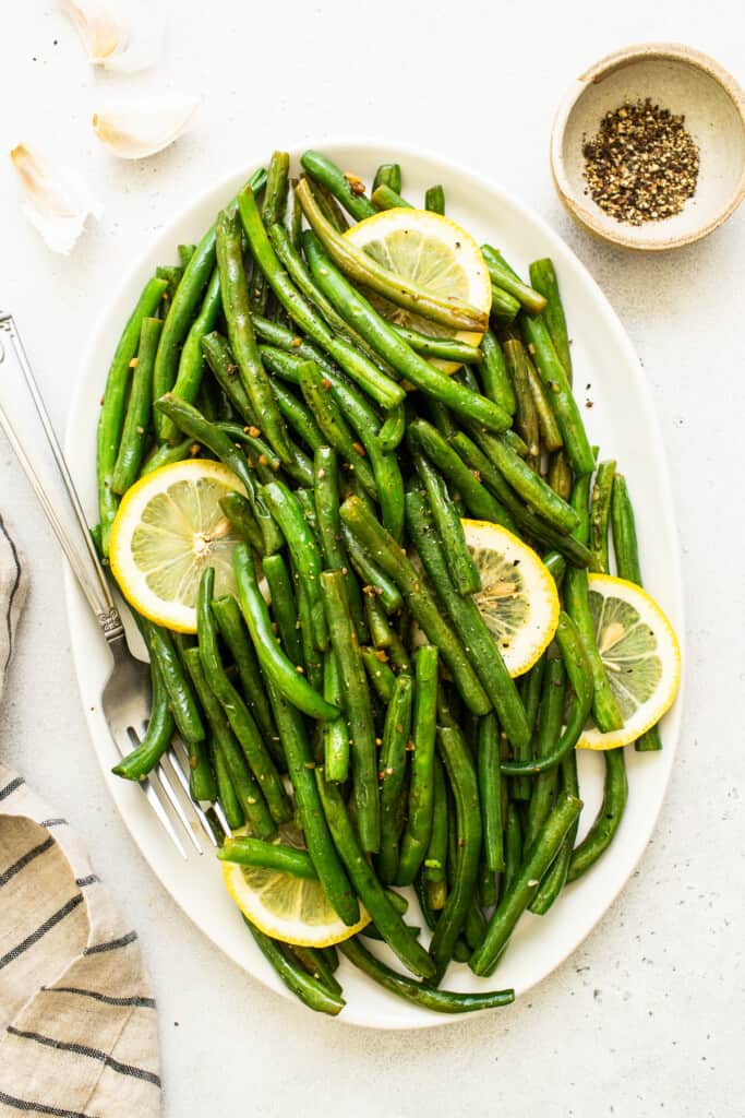 cooked green beans on platter.