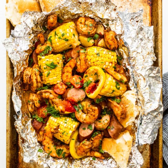 Grilled shrimp foil packets full of veggies and shrimp.