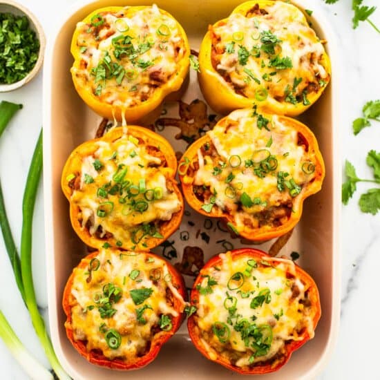 Mexican stuffed peppers in a baking dish.