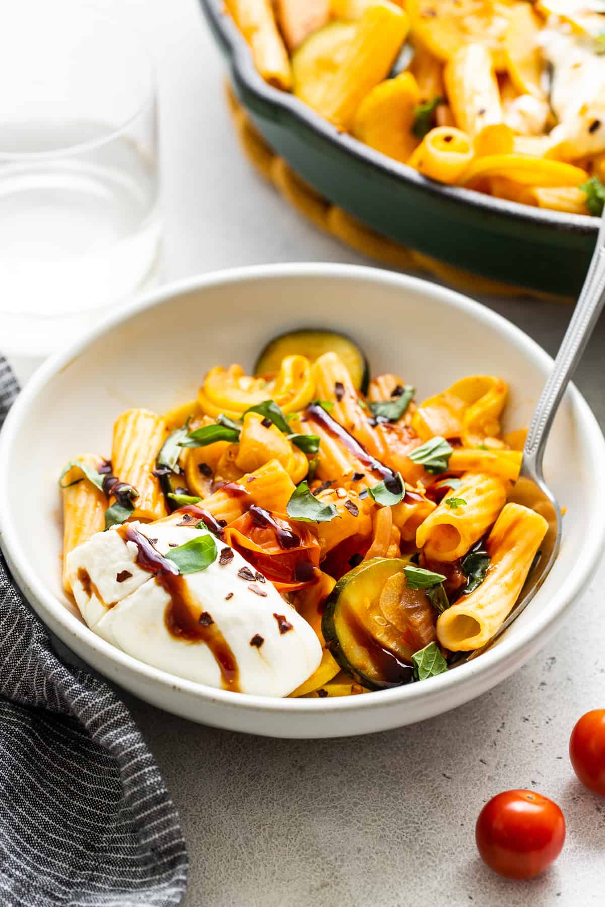 Summer squash pasta in a bowl with burrata. 