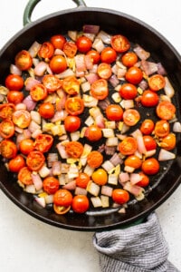 Tomatoes and onions in a skillet.