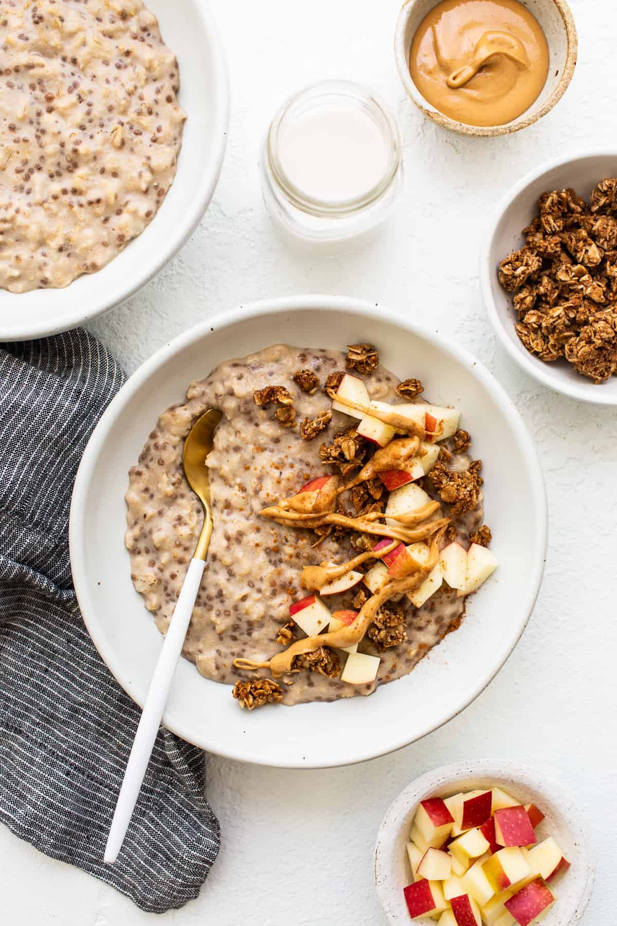 Apple cinnamon oatmeal in a bowl with a spoon.