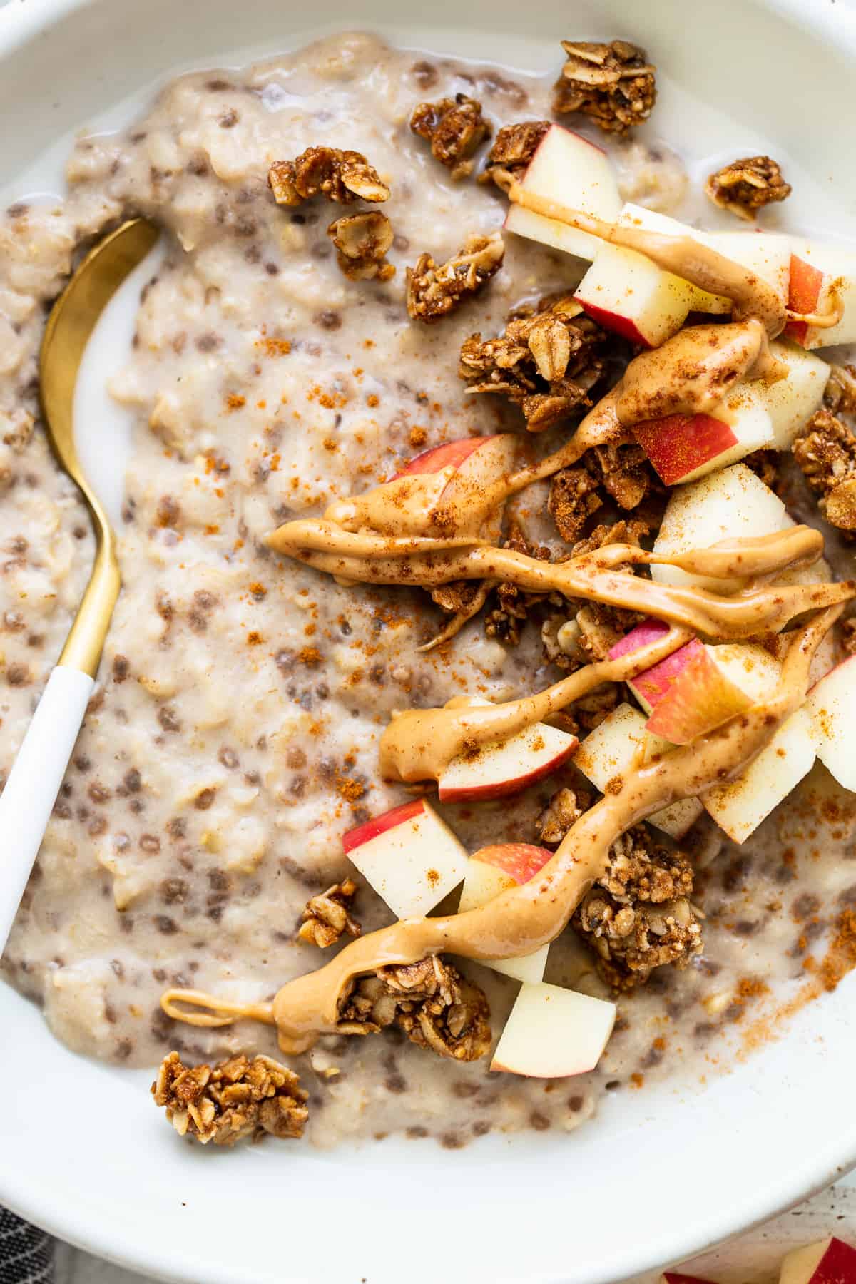 Apple cinnamon oatmeal topped with nut butter and sliced apples.