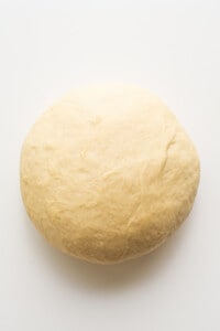 A ball of dough on a white surface.