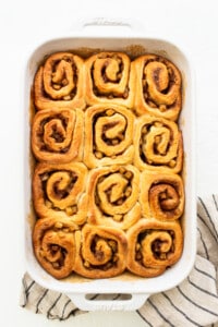 Cinnamon rolls in a white baking dish.