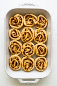 Apple cinnamon rolls in a baking dish.