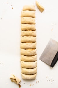 A slice of bread with a knife next to it.