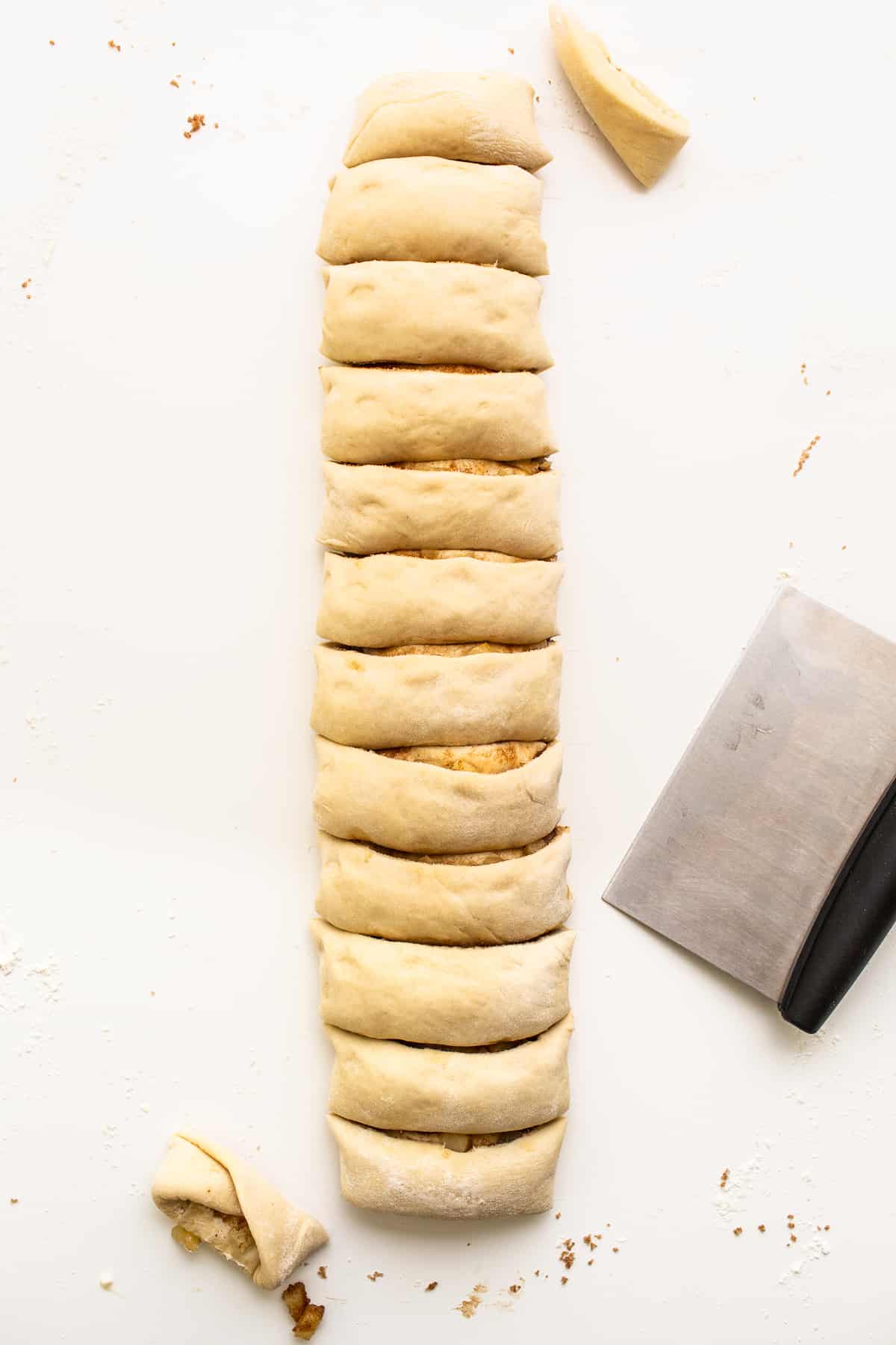 Apple cinnamon roll dough cut into rolls.