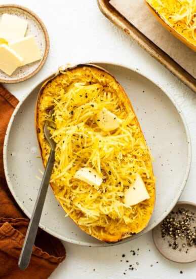 roasted spaghetti squash with butter on plate.