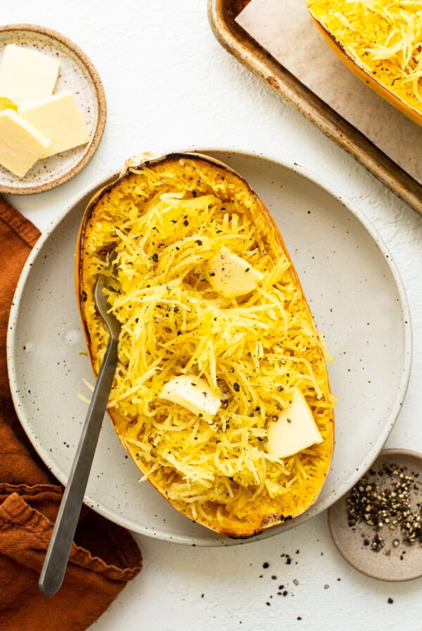 roasted spaghetti squash with butter on plate.