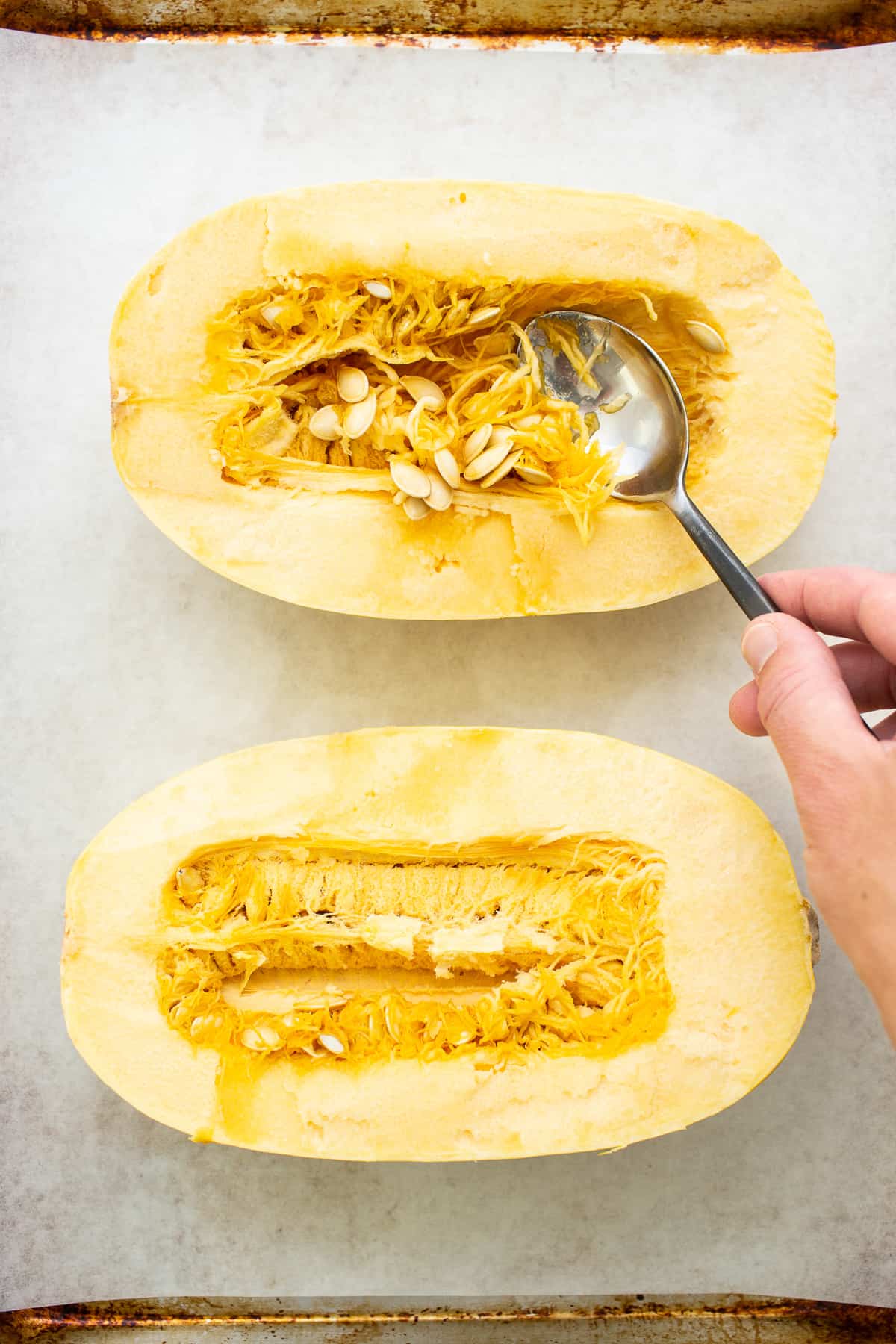 spooning out innards of squash.