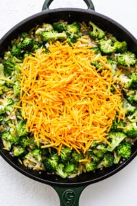 adding cheese to skillet.