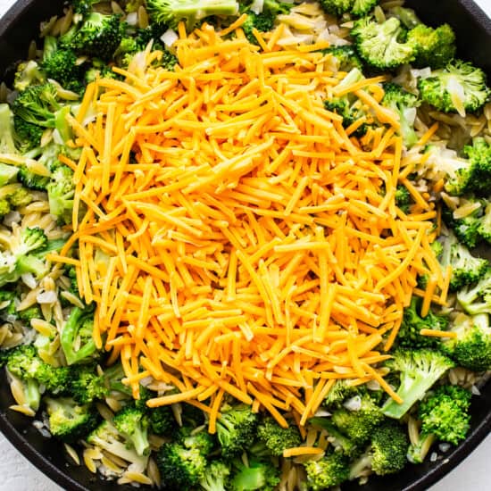 adding cheese to skillet.