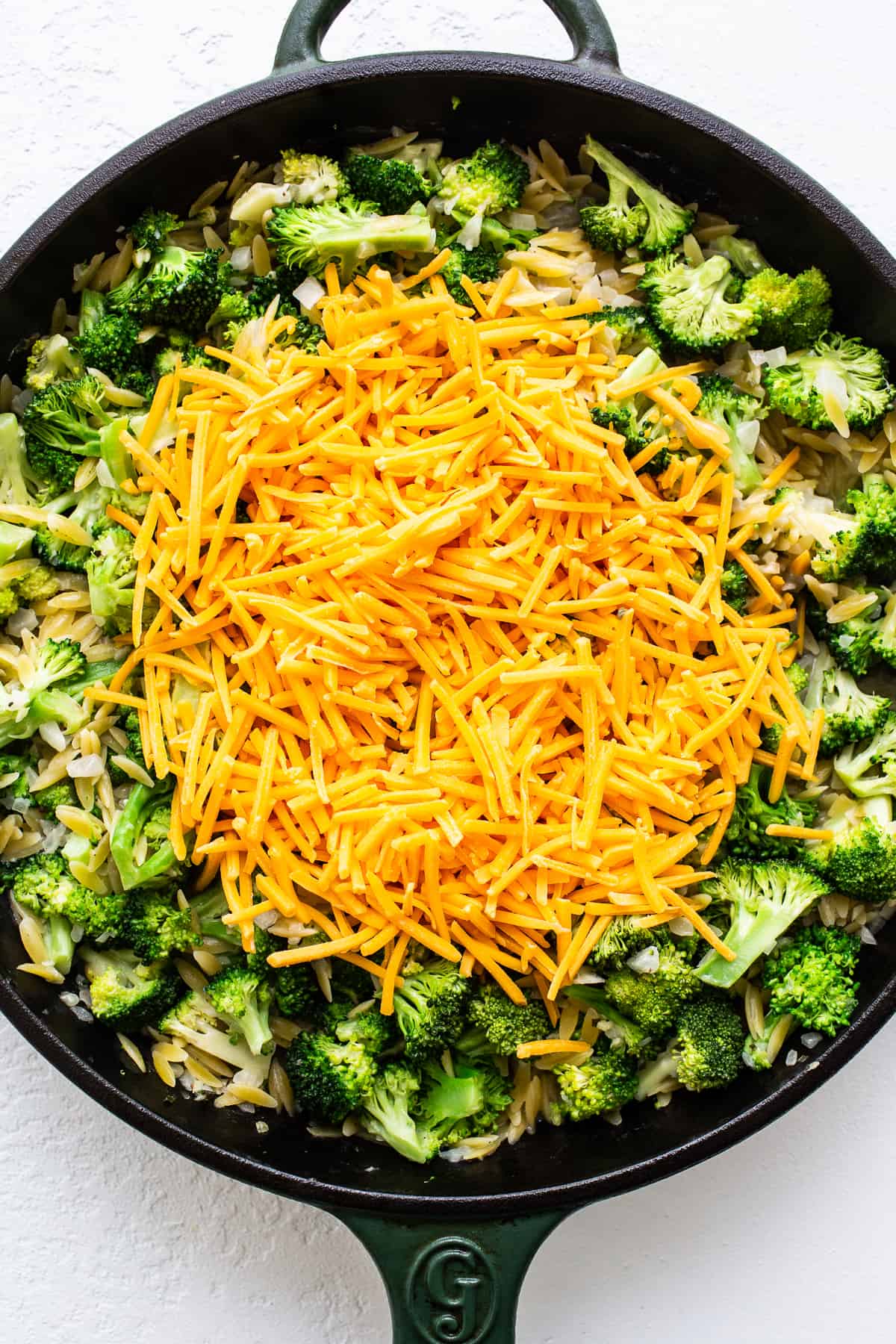cheese on top of broccoli and orzo.