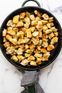 pan frying croutons in cast iron skillet.