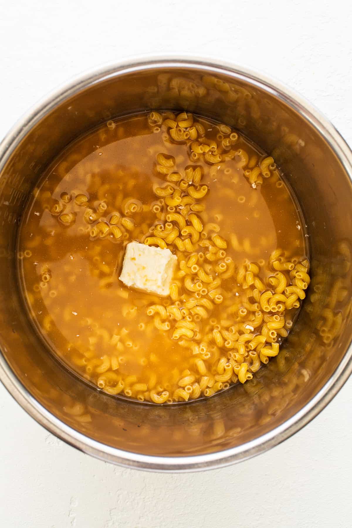 noodles, butter, and broth in Instant Pot.