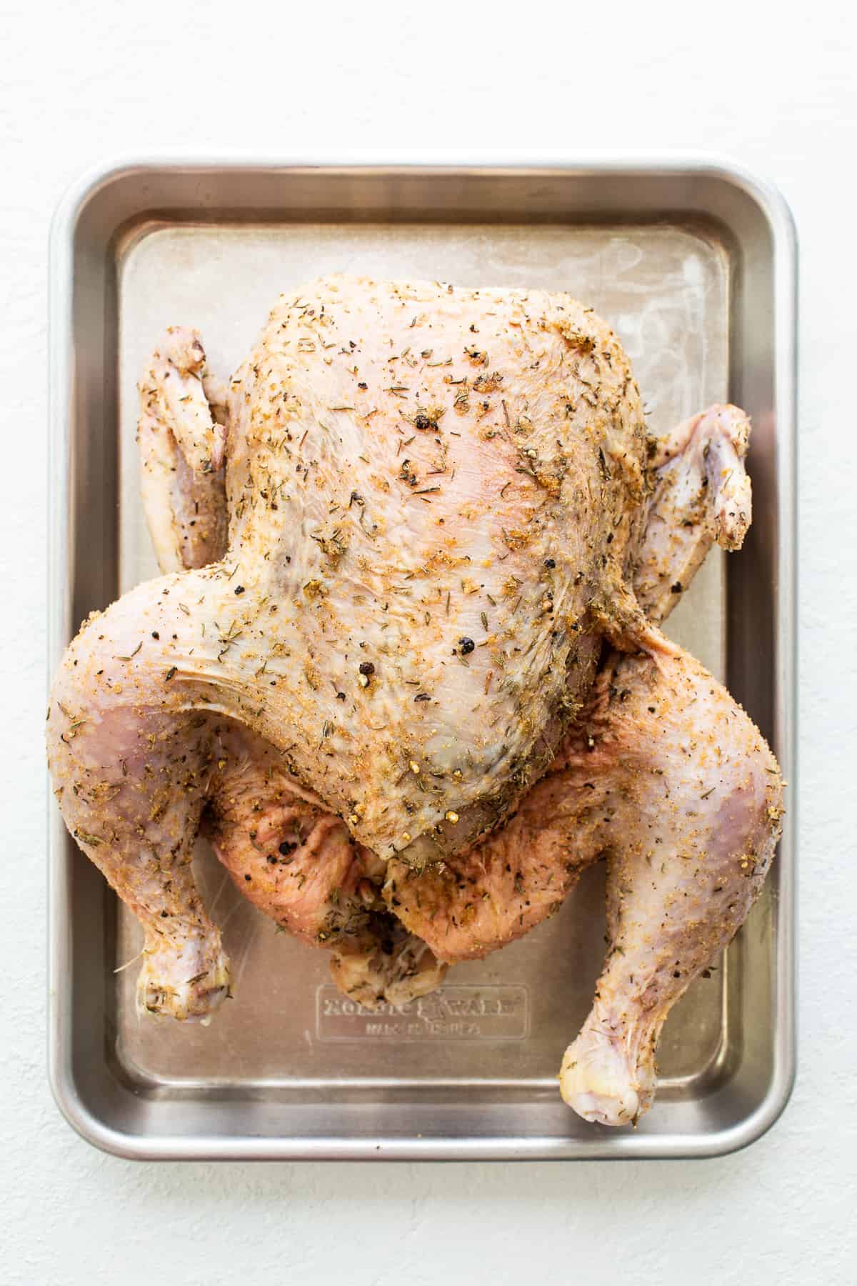whole chicken on sheet pan.