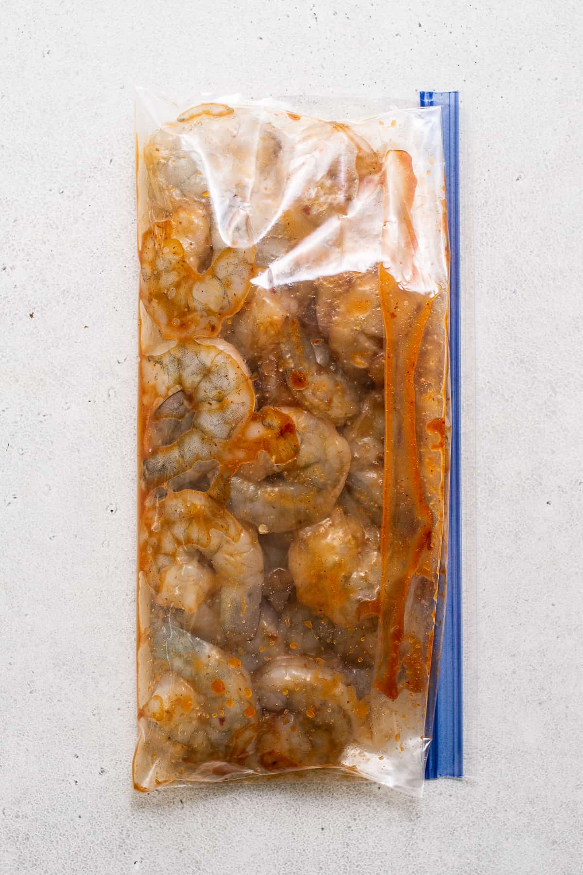 shrimp marinating in sauce.