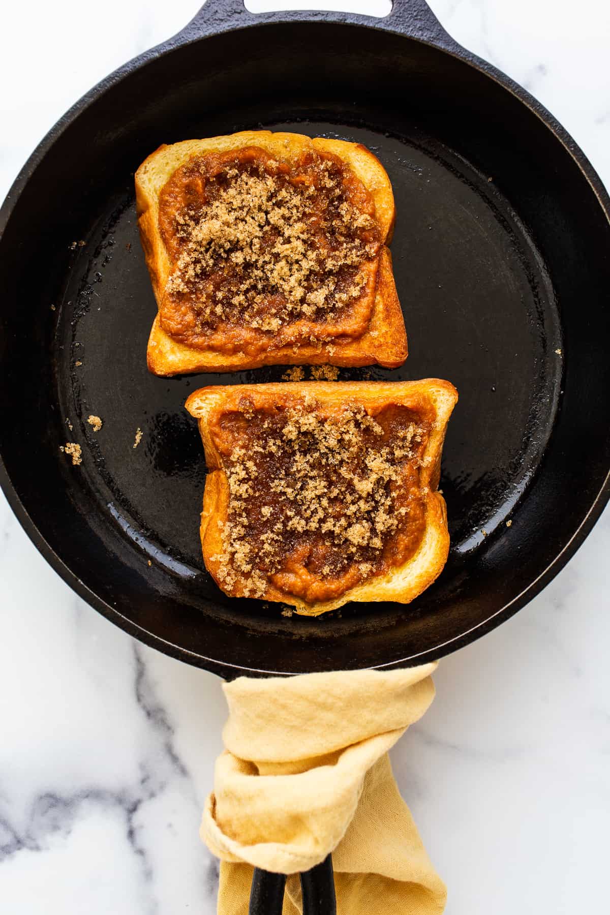 Pumpkin creme brulee french toast in a cast iron skillet.