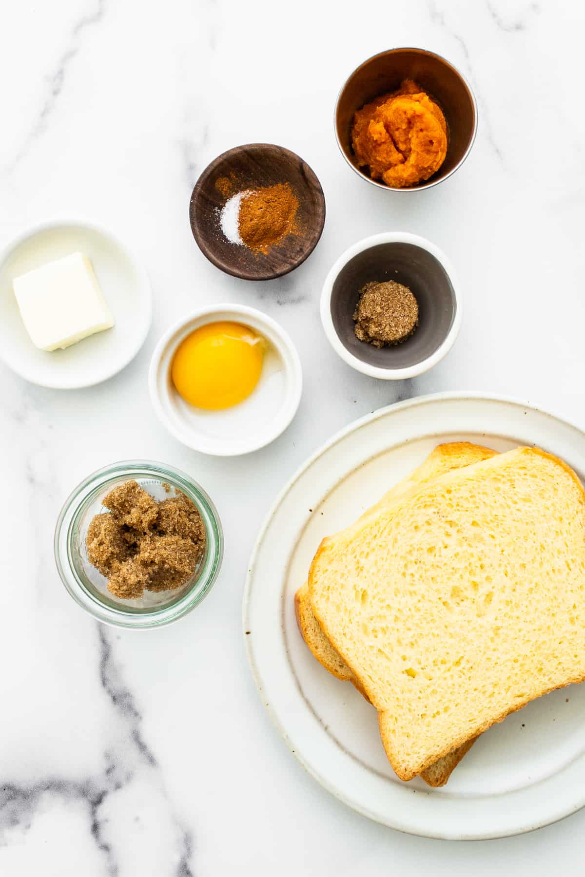 Ingredients for pumpkin creme brulee french toast in bowls.