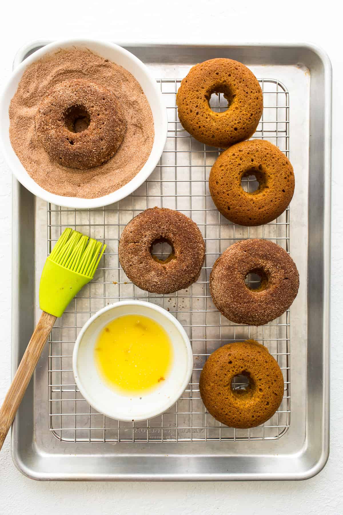 brushing donuts with butter.