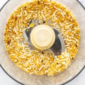 A food processor filled with nuts and seeds.
