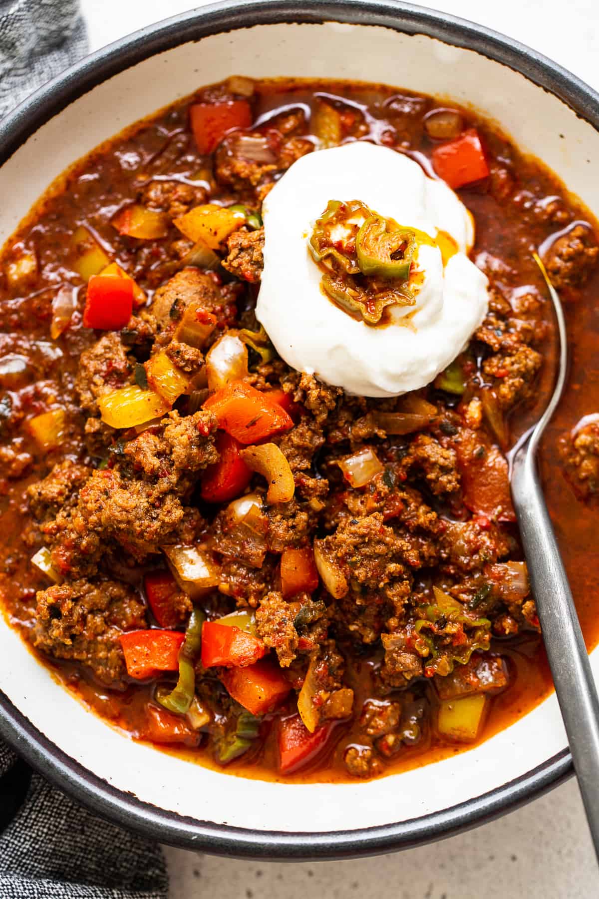 Texas chili topped with sour cream in a bowl. 