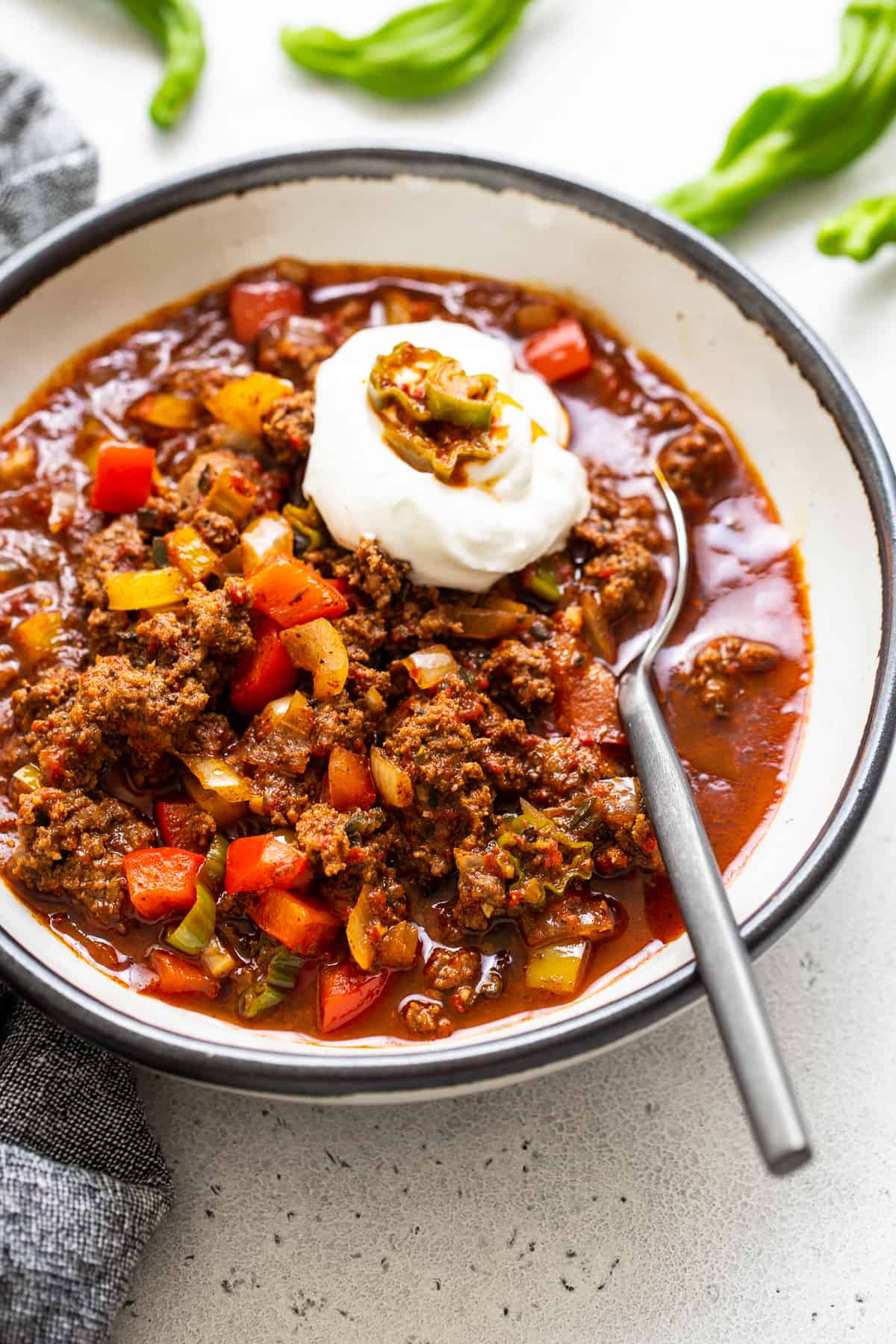 Texas chili in a bowl with sour cream on top 