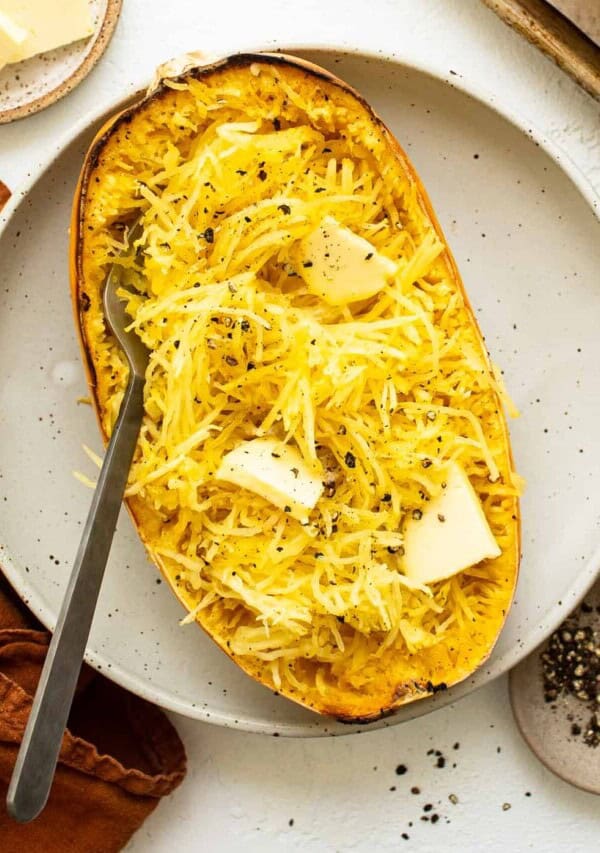 roasted spaghetti squash with butter on plate.