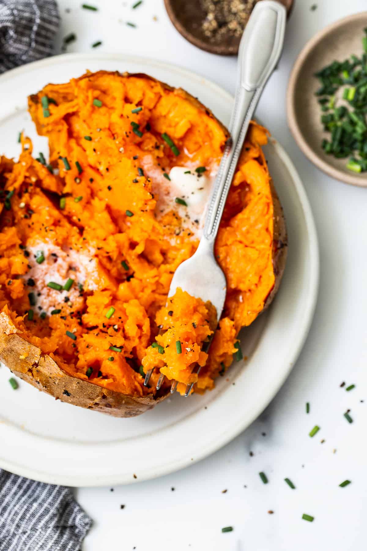 Baked sweet potato on a fork.