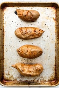 Grilled sweet potatoes on a baking sheet.