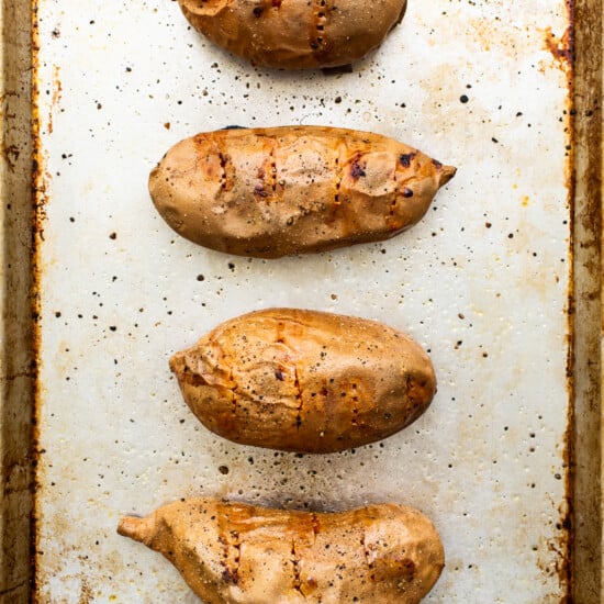 Grilled sweet potatoes on a baking sheet.