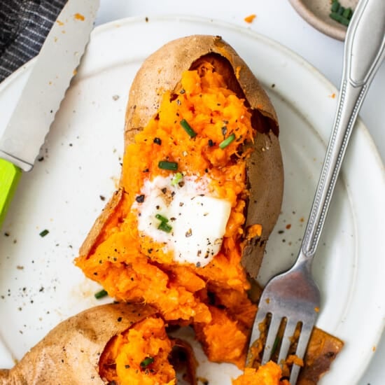 Sweet potatoes on a plate with a fork.
