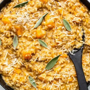 Squash risotto in a skillet with sage.