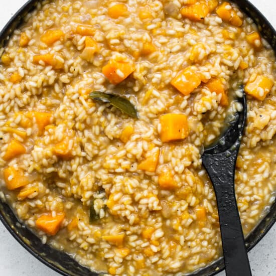 A skillet filled with risotto and squash.
