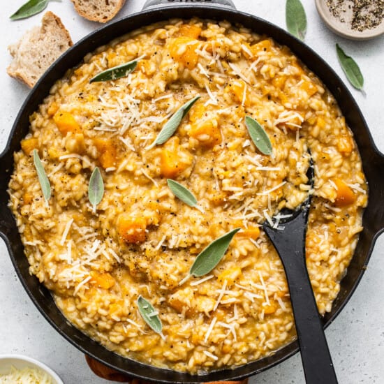 Fit Foodie Finds creates a nutritious pumpkin risotto in a skillet, filled with the flavors of sage and parmesan.