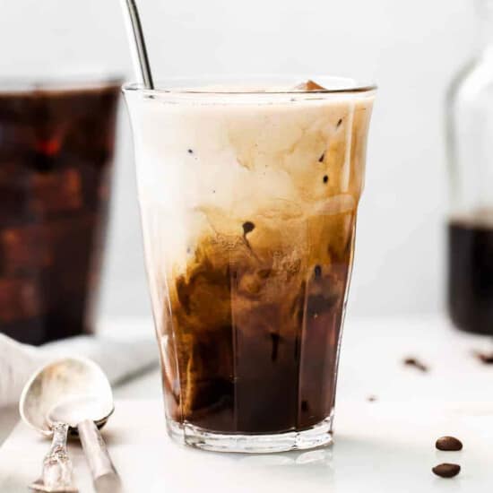 Cold brewed iced latte coffee on plastic cup, side view with