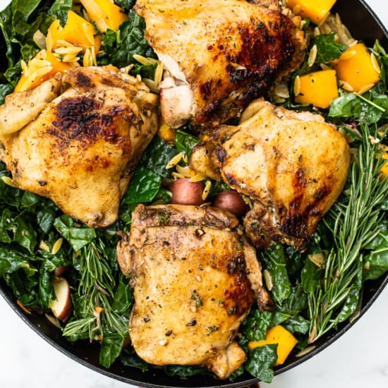 Chicken and veggies in a skillet.