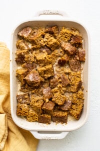 submerging pumpkin bread in baking dish.