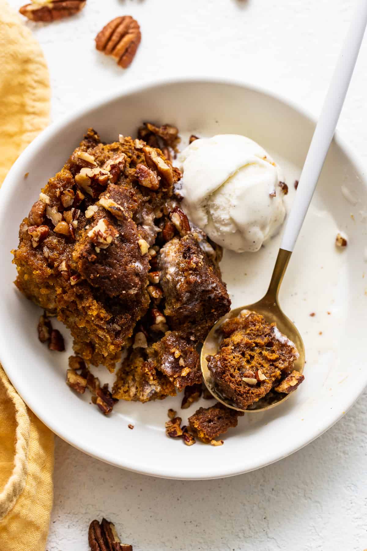 pumpkin bread pudding in bowl with ice cream.