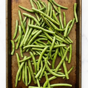Roasted green beans on a baking sheet.