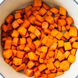 Cubed sweet potatoes in a blue pot.