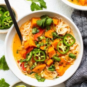 A bowl of thai sweet potato noodle soup.