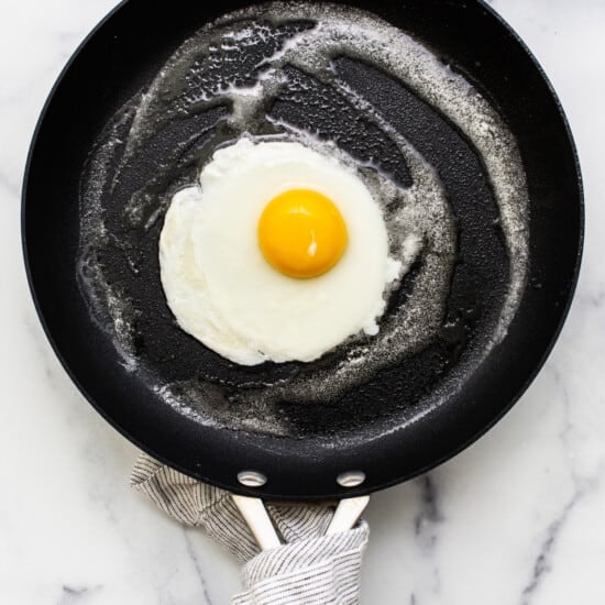 A cooked egg in a pan.