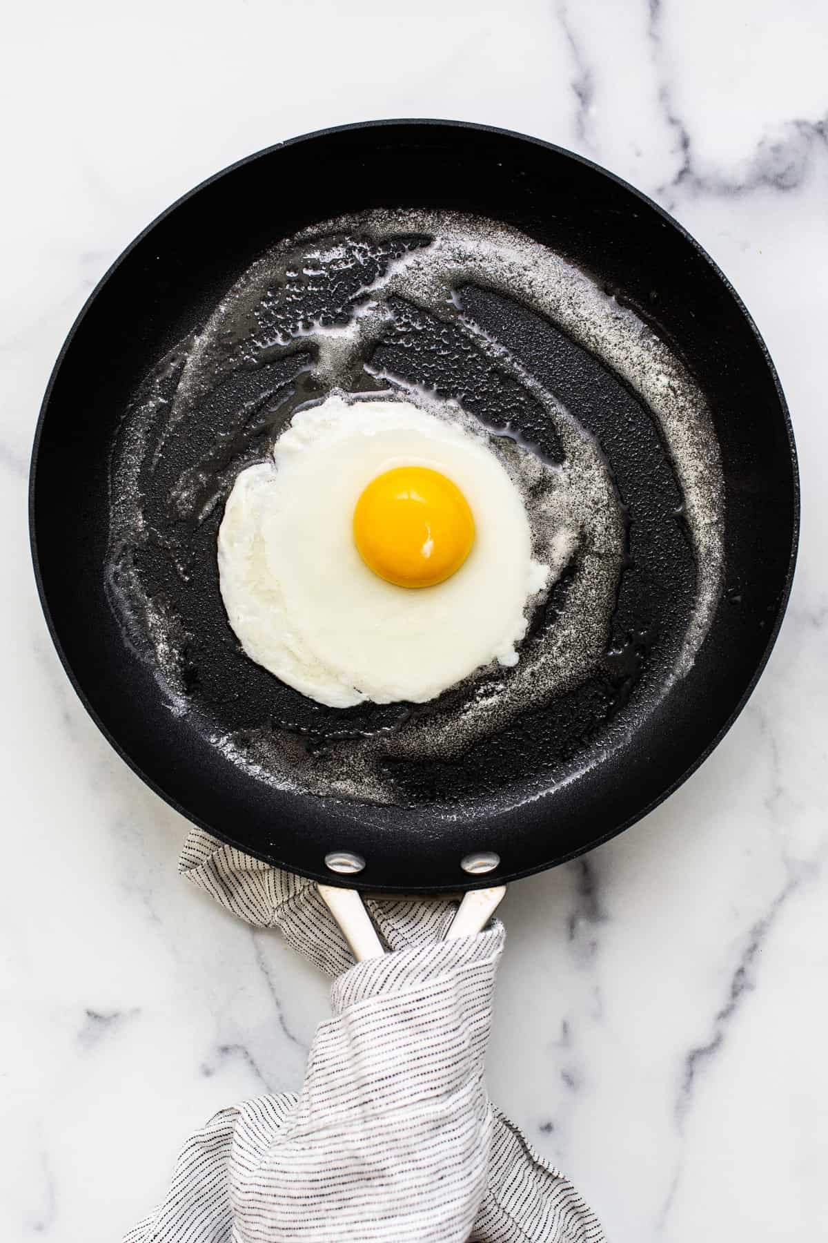 A cooked egg in a pan.