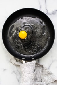 Cracked egg in a pan.