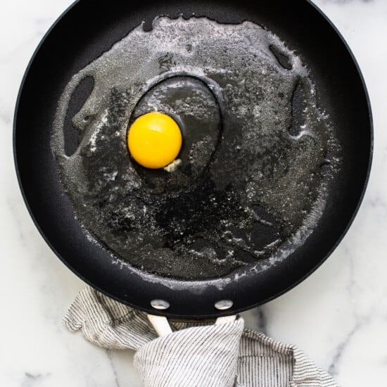 Cracked egg in a pan.