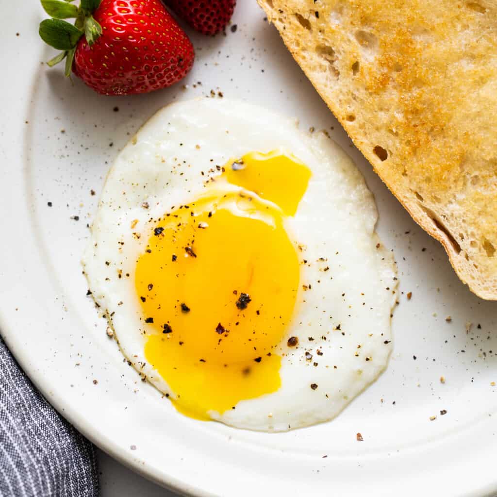 A sunny side up egg on a plate.