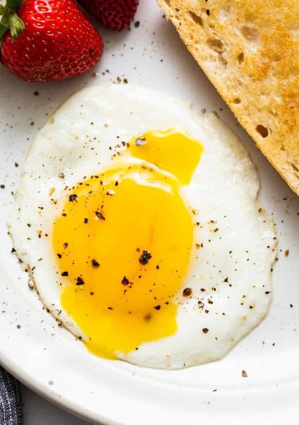 A sunny side up egg on a plate.